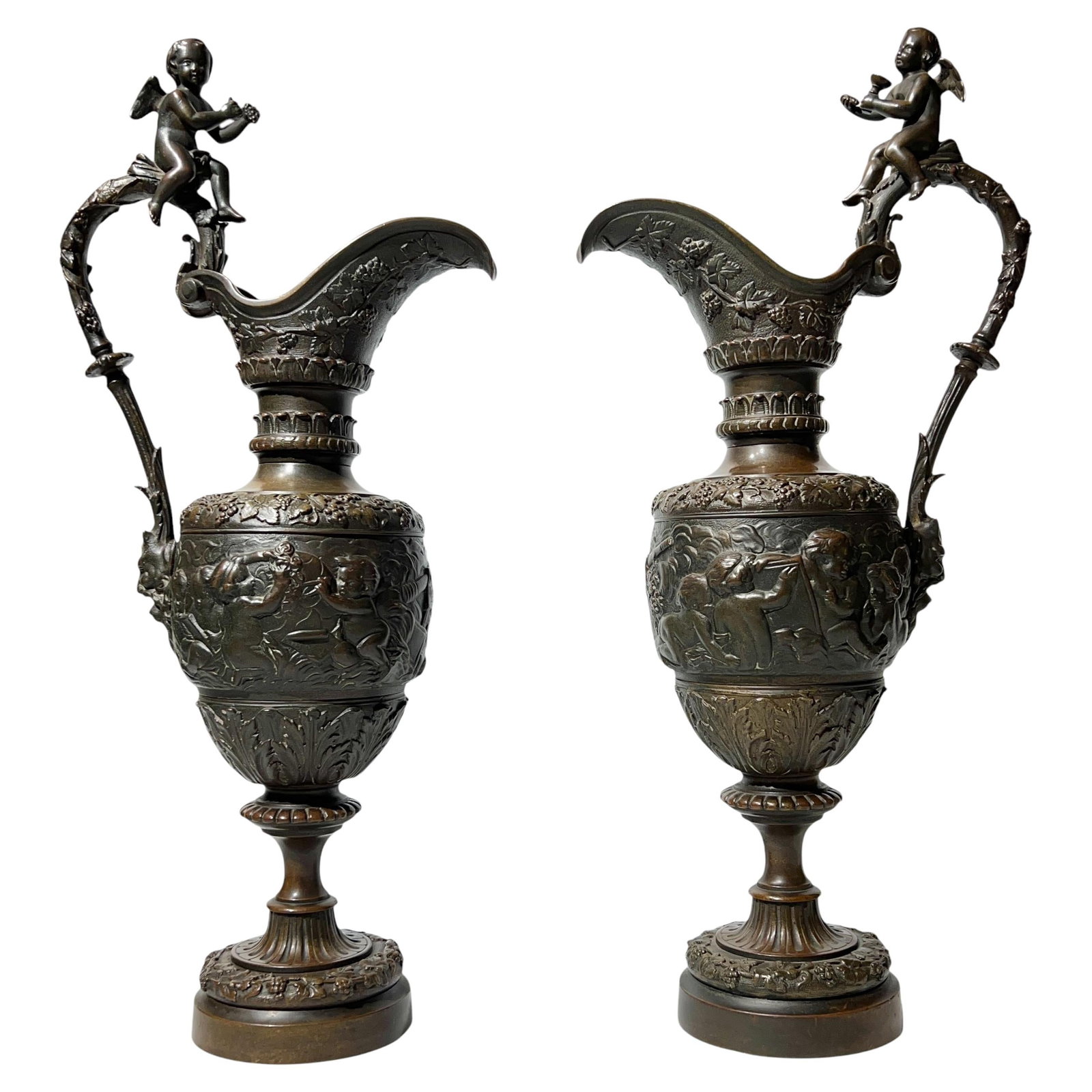 Set of Two 19th Century Bronze Neoclassical Revival Ewers: Set of Two 19th Century Bronze Neoclassical Revival Ewers This pair of late 19th century Neoclassical Revival bronze ewers features intricate patinated surfaces adorned with detailed motifs, including