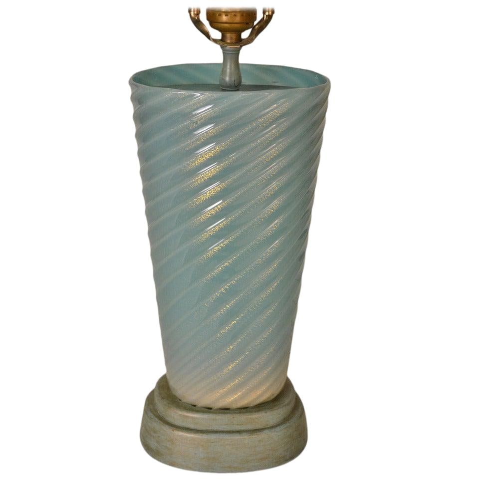 Turquoise Murano Glass Lamp with Gold Flake Inclusion: Turquoise Murano Glass Lamp with Gold Flake Inclusion This stunning Murano glass lamp features an elegant turquoise swirl design adorned with gold flake inclusions, embodying the charm of Hollywood Re