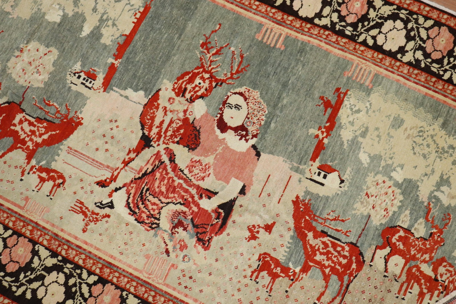 4' 6" x 8' 8" Russian Karabagh Pictorial Rug with Reindeer: 4' 6" x 8' 8" Russian Karabagh Pictorial Rug with Reindeer Mid-20th century pictorial Russian Karabagh rug featuring a scene of reindeers floating around a lady. The rug has a tomato red background wi