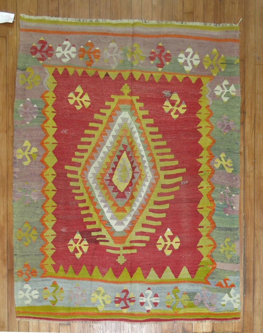 4' 2" x 5' Vintage Turkish Kilim Rug: 4' 2" x 5' Vintage Turkish Kilim Rug Vintage Turkish kilim in a square format from the mid-20th century. This pre-owned woven textile features a colorful design with a central diamond motif framed by 