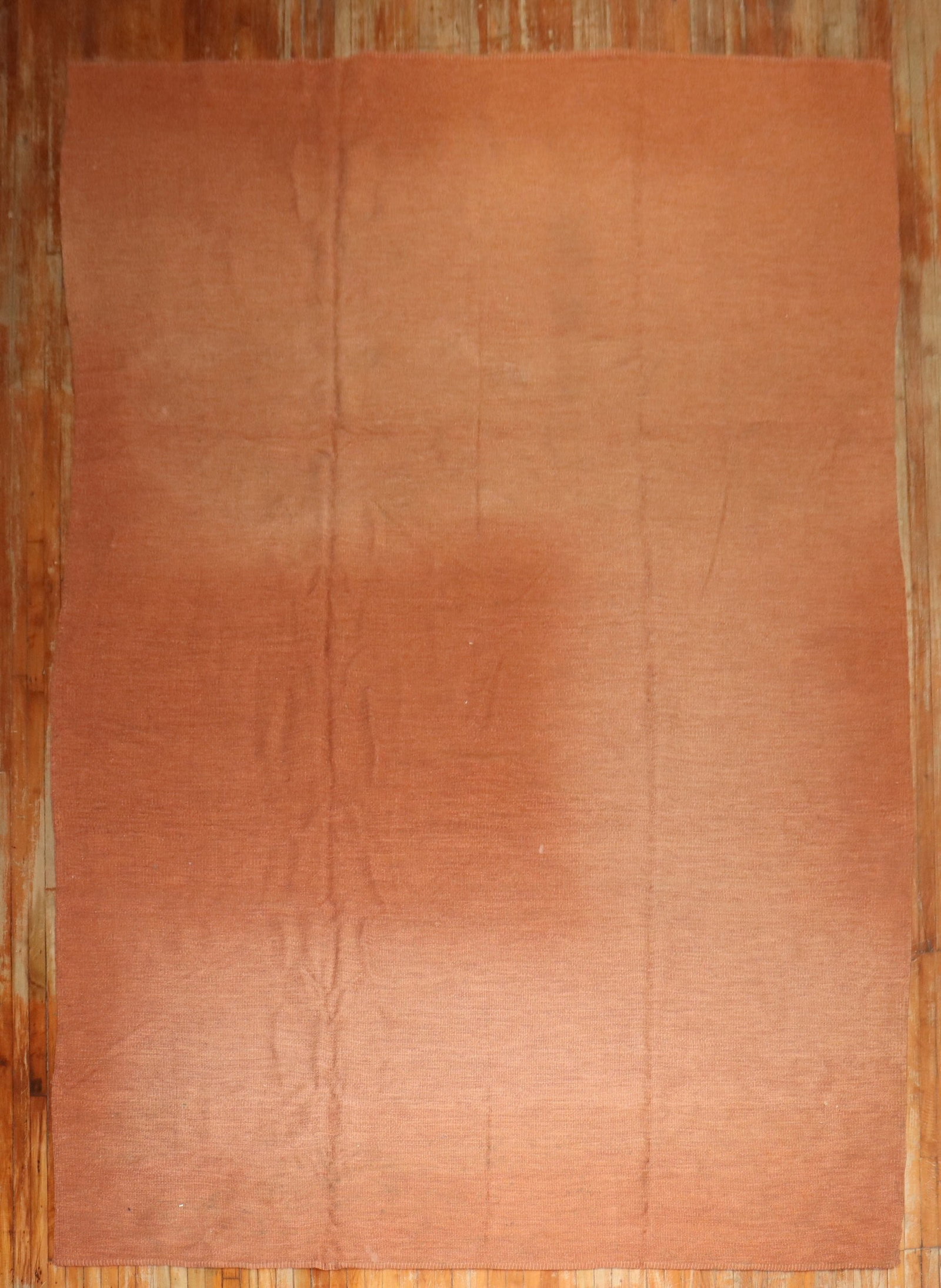 9' 5" x 14' 5" Persian Kilim Rug in Rust: 9' 5" x 14' 5" Persian Kilim Rug in Rust Mid 20th century Persian Kilim with a solid field in a blotchy rust color. This pre-owned room-size rug offers a simple, understated look grounded in its vinta