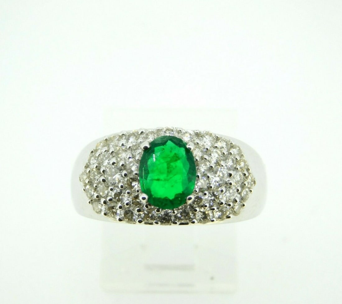 14k White Gold .81ct Emerald Ring with 1.17ct Diamonds GIA Certified: 14k White Gold .81ct Emerald Ring with 1.17ct Diamonds GIA Certified This exquisite 14k white gold ring features a stunning .81ct genuine natural emerald, beautifully complemented by a total of