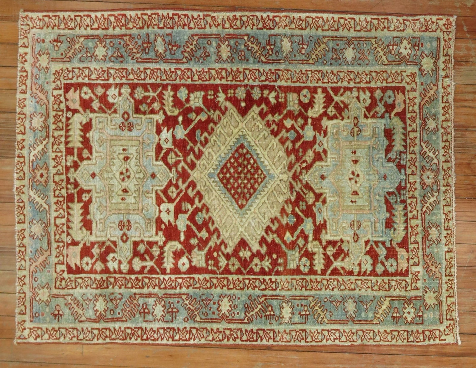 2' 9" x 3' 5" Persian Heriz Serapi Rug Red Field Blue Border: 2' 9" x 3' 5" Persian Heriz Serapi Rug Red Field Blue Border Antique Persian Heriz rug from the 1920s featuring a cranberry red field and blue border. Classified as a Serapi/Heriz type, this pre-owned