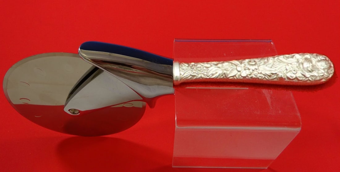 Kirk Repousse Sterling Silver Pizza Cutter Custom Made 9 1/4": Kirk Repousse Sterling Silver Pizza Cutter Custom Made 9 1/4" This exquisite pizza cutter features the renowned Repousse pattern by Kirk, crafted from high-quality sterling silver. Measuring 9 1/4" in