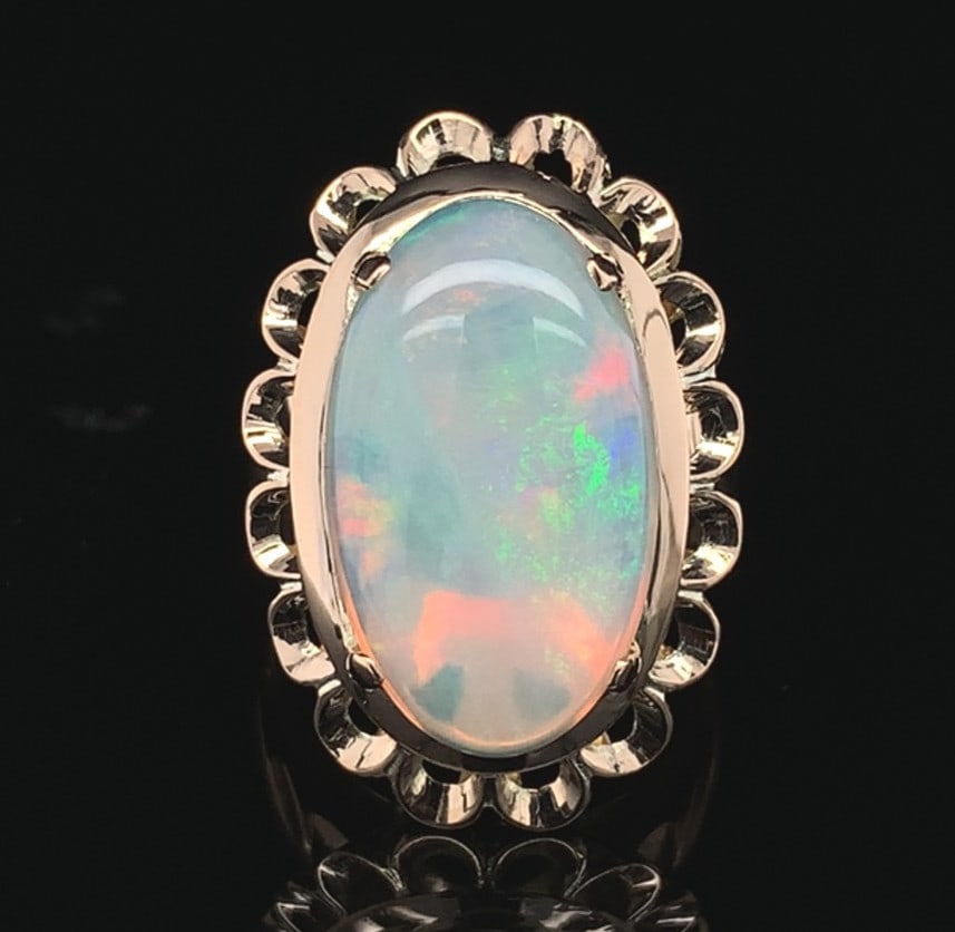 Australian Opal Cabochon Ring in 12k Yellow Gold Size 5.75 4.82ct: Australian Opal Cabochon Ring in 12k Yellow Gold Size 5.75 4.82ct This vintage ring showcases a genuine natural Australian opal set in 12k yellow gold. The large oval cabochon cut opal weighs 4.82 car