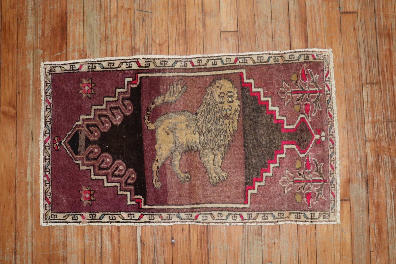 1' 10" x 3' 2" Pictorial Turkish Yastik Rug with Lion Motif: 1' 10" x 3' 2" Pictorial Turkish Yastik Rug with Lion Motif Mid-20th century authentic Turkish pictorial rug featuring a lion motif on a striated purple ground. This pre-owned yastik offers a distinct