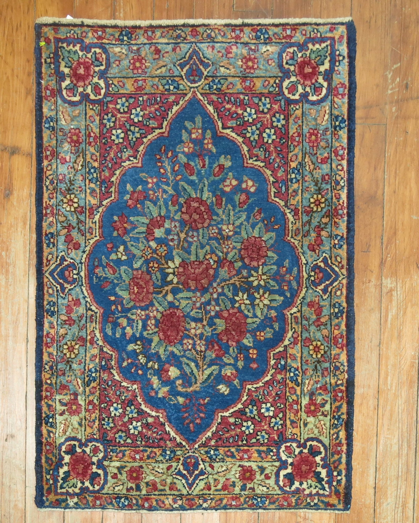 1' 6" x 2' 4" Antique Kerman Yastik Rug Royal Blue Floral: 1' 6" x 2' 4" Antique Kerman Yastik Rug Royal Blue Floral Early 20th century Kerman yastik rug with a royal blue field and floral design. This pre-owned piece features a classic floral pattern consist