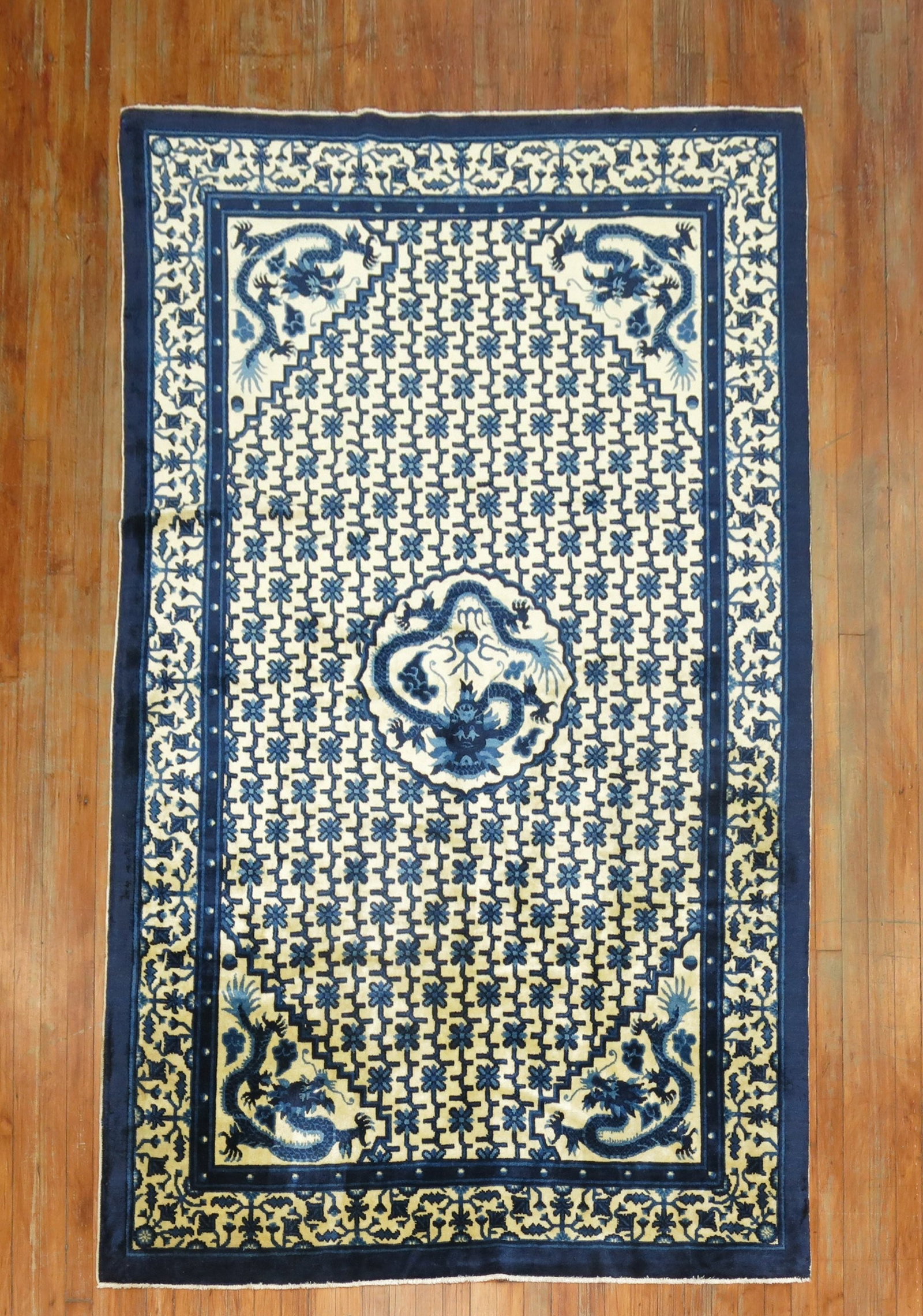 5' x 8' Chinese Peking rug with dragon medallion: 5' x 8' Chinese Peking rug with dragon medallion Early 20th century Chinese Peking rug featuring a dragon medallion pattern. This pre-owned pictorial rug presents a classic design associated with Chin
