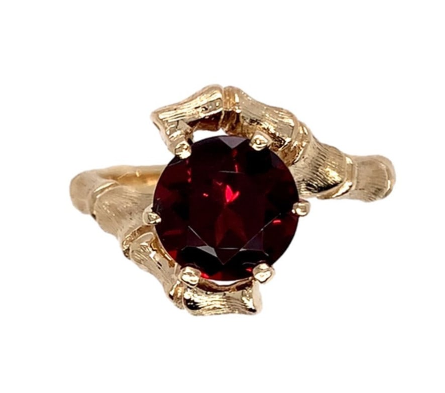 14k Yellow Gold Bamboo Ring with 2.20ct Round Red Garnet: 14k Yellow Gold Bamboo Ring with 2.20ct Round Red Garnet This exquisite ring showcases a stunning 2.20 carat round brilliant cut garnet, set in a unique bamboo design crafted from 14k yellow gold. The