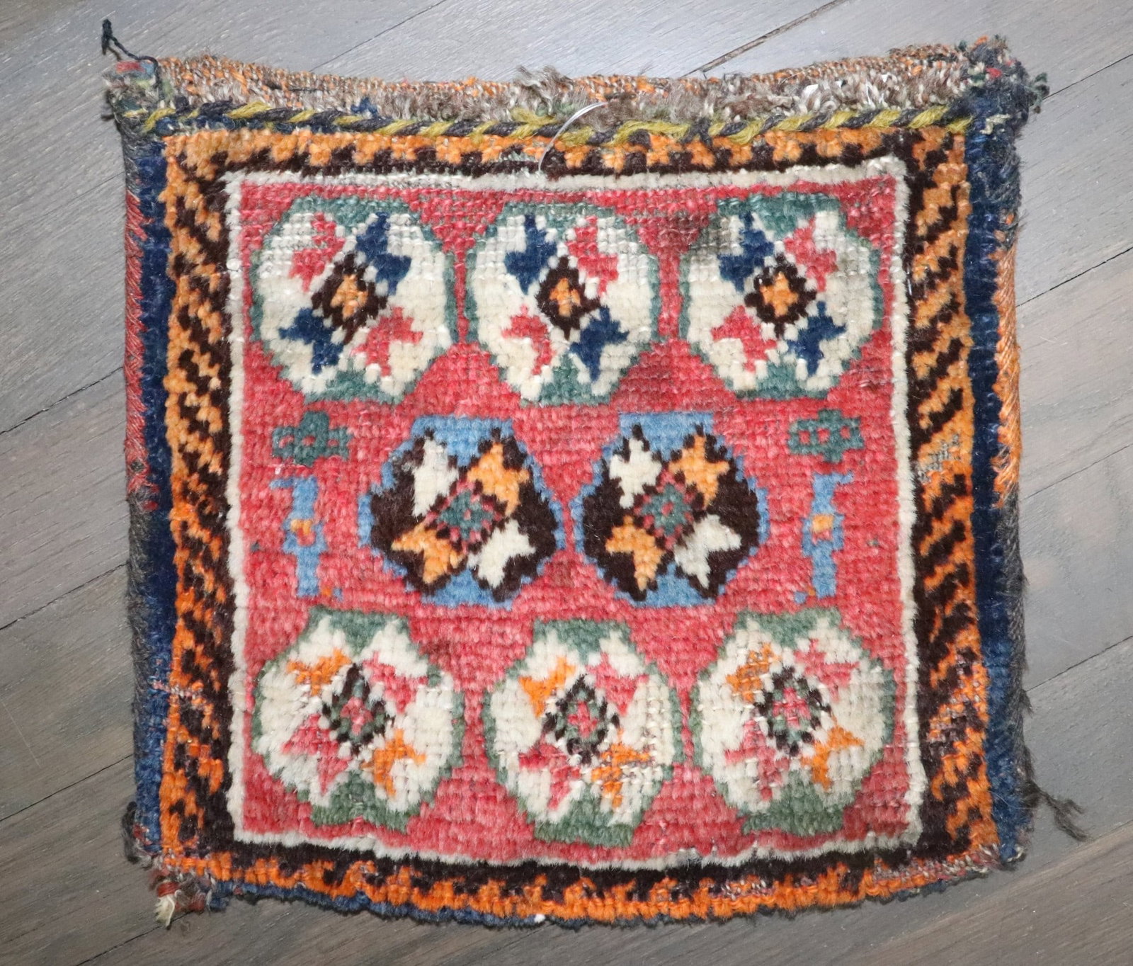 Early 20th Century Kurd Bagface Square Yastik 10" x 11": Early 20th Century Kurd Bagface Square Yastik 10" x 11" Early 20th century Kurd small bagface rug in a square yastik form. This pre-owned textile piece offers a compact format consistent with the orig