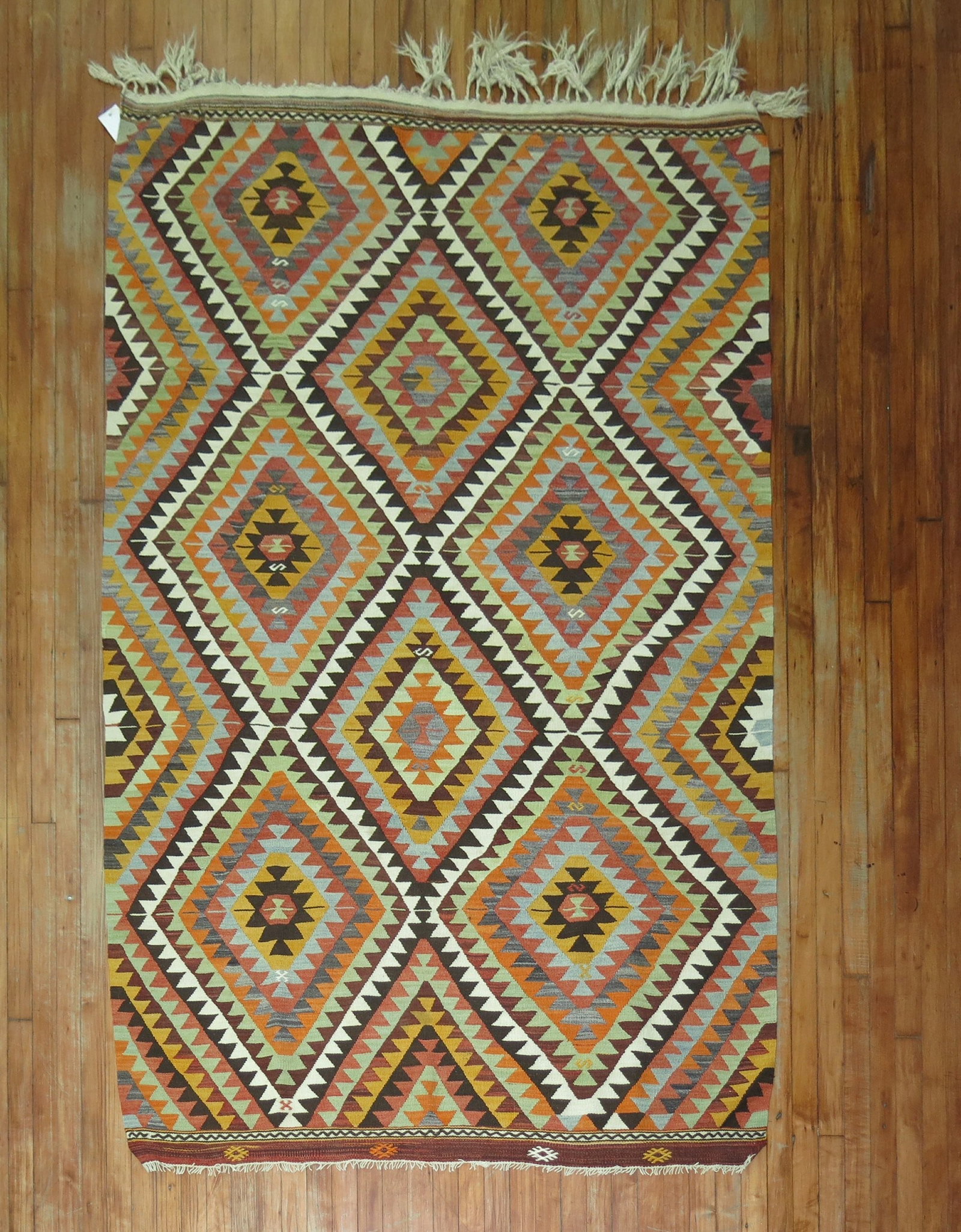 5' x 7' 5" Mid 20th Century Turkish Tribal Kilim Rug: 5' x 7' 5" Mid 20th Century Turkish Tribal Kilim Rug Mid 20th century tribal Turkish kilim with a geometric diamond pattern. This pre-owned woven rug offers a classic flat-weave kilim style and rectan