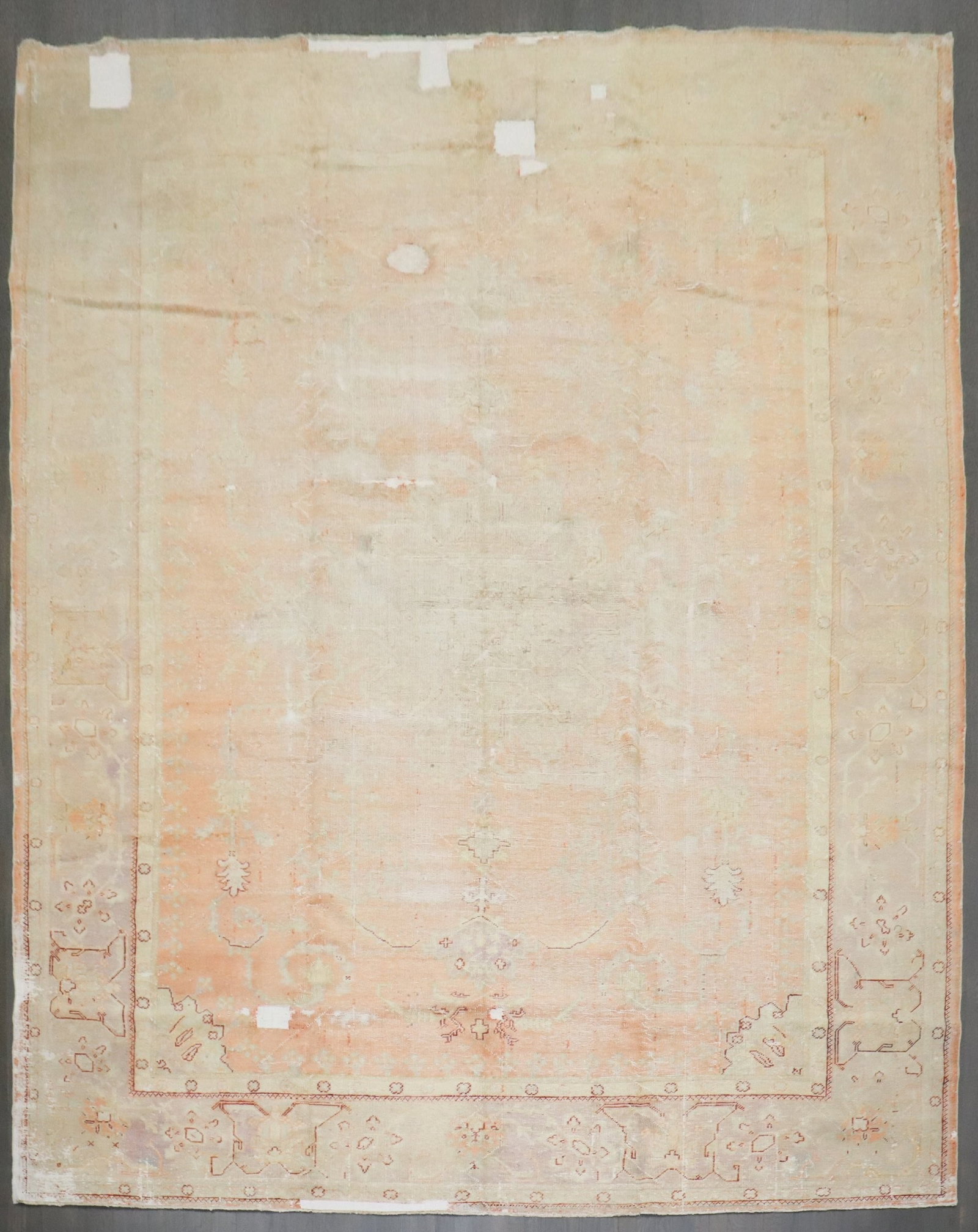 9' 10" x 13' Early 20th Century Turkish Oushak Room Rug: 9' 10" x 13' Early 20th Century Turkish Oushak Room Rug Early 20th century Turkish Oushak rug in a soft orange-peach palette with a worn, distressed look. This pre-owned room-size rug is described as 