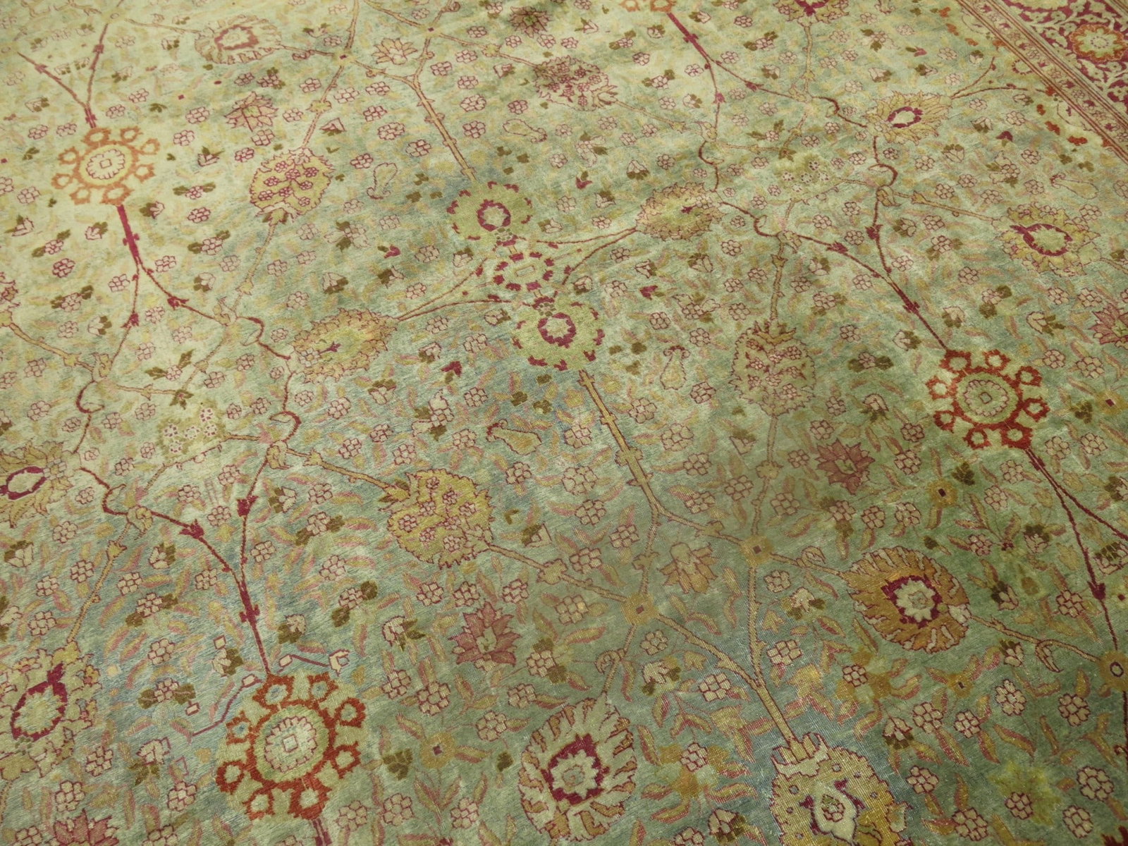 9' 4" x 11' 9" Persian Tabriz room rug in green and ruby red: 9' 4" x 11' 9" Persian Tabriz room rug in green and ruby red Circa 1920 Persian Tabriz room rug with a green background and ruby red accents. The design features intricate floral patterning and is off
