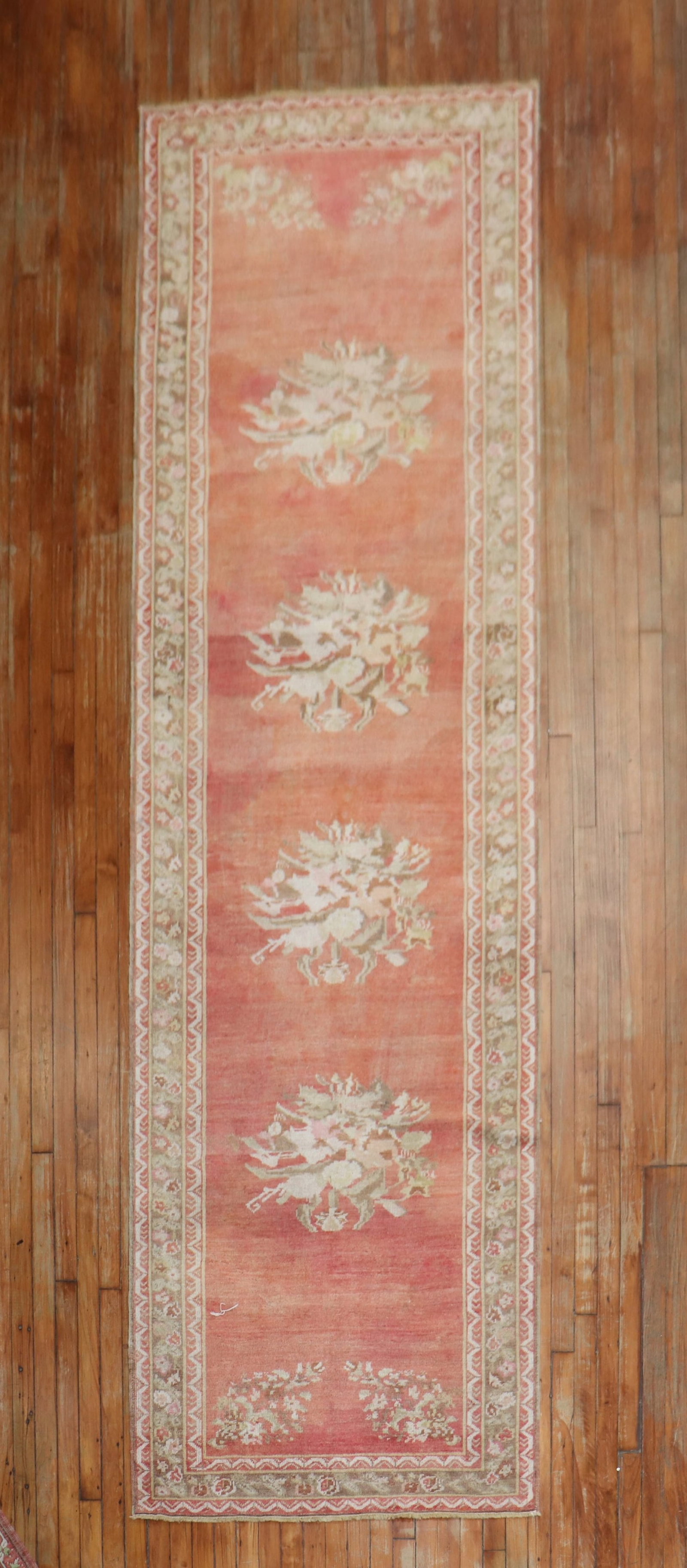 3' 5" x 12' 9" Turkish Ghiordes floral runner in muted red: 3' 5" x 12' 9" Turkish Ghiordes floral runner in muted red Early 20th century Turkish Ghiordes runner with a muted red field and floral design. This pre-owned antique runner is identified as Ghiordes 