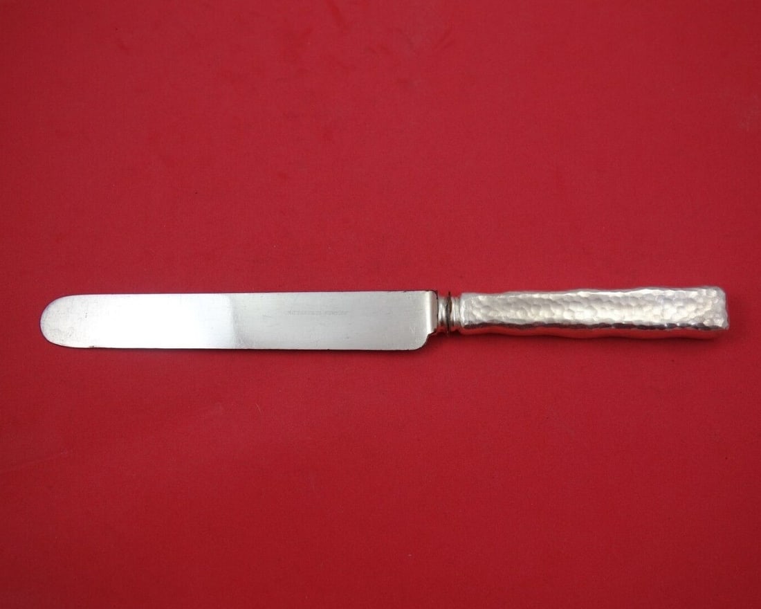 Tiffany & Co Lap Over Edge Hammered Sterling Silver Banquet Knife 10 3/8 Inches: Tiffany & Co Lap Over Edge Hammered Sterling Silver Banquet Knife 10 3/8 Inches This exquisite banquet knife from Tiffany & Co. showcases the elegant Lap Over Edge Hammered pattern. Crafted from high-