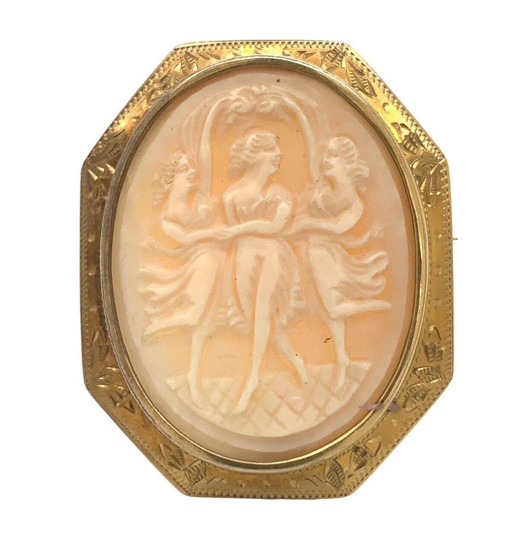 10k Yellow Gold Shell Cameo Pin Pendant Three Graces: 10k Yellow Gold Shell Cameo Pin Pendant Three Graces This vintage pin pendant features a carved shell cameo depicting the Three Graces, set in a hand-engraved 10k yellow gold frame with decorative lea