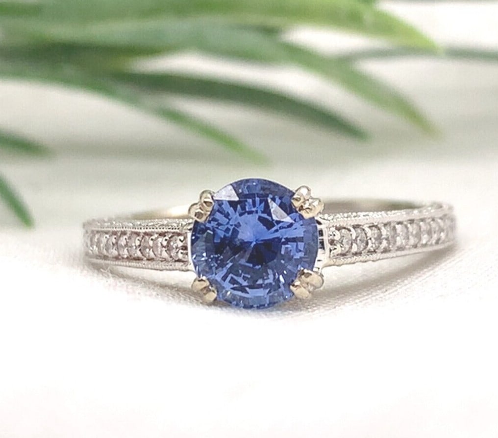 14k White Gold Sapphire Diamond Accent Ring Size 6.5: 14k White Gold Sapphire Diamond Accent Ring Size 6.5 This elegant ring is crafted from 14k white gold and showcases a genuine, earth-mined round brilliant cut blue sapphire weighing approximately 1.15