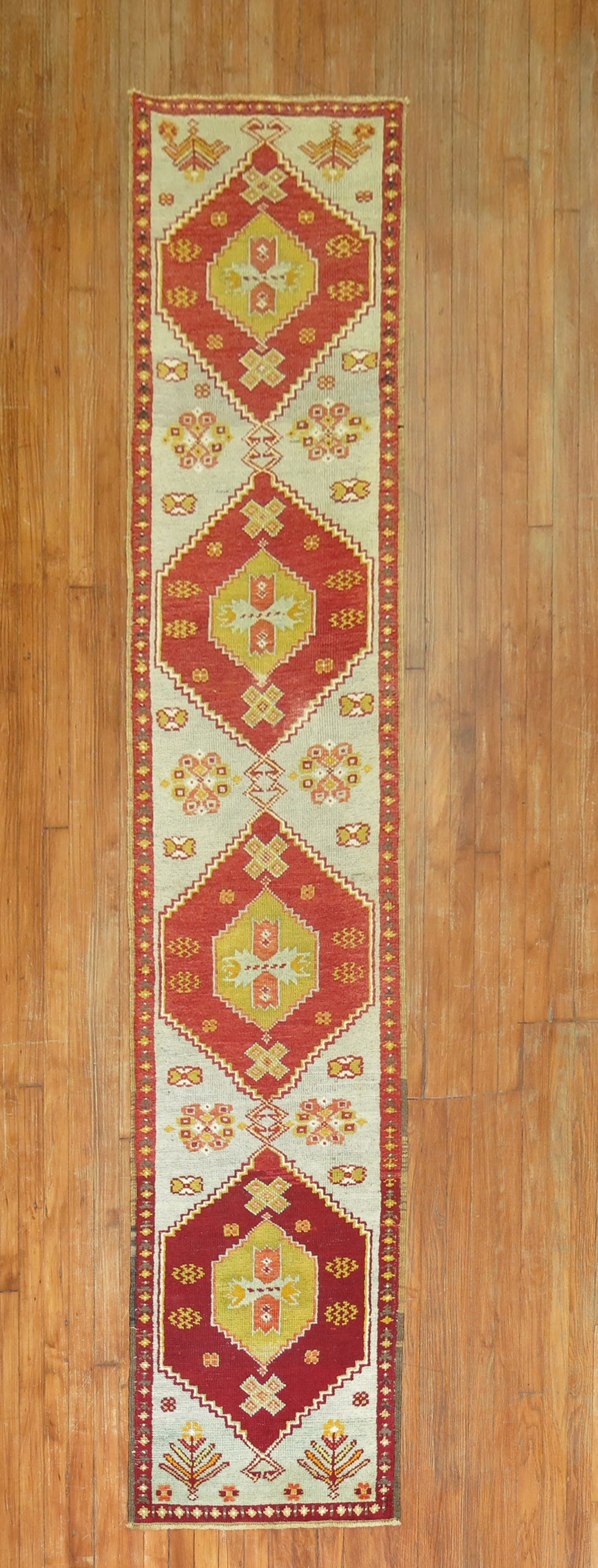 2' 1" x 9' 9" Turkish Anatolian runner mid 20th century: 2' 1" x 9' 9" Turkish Anatolian runner mid 20th century Narrow Turkish Anatolian runner from the middle of the 20th century, featuring three bright red medallions on an icy blue field. This pre-owned 