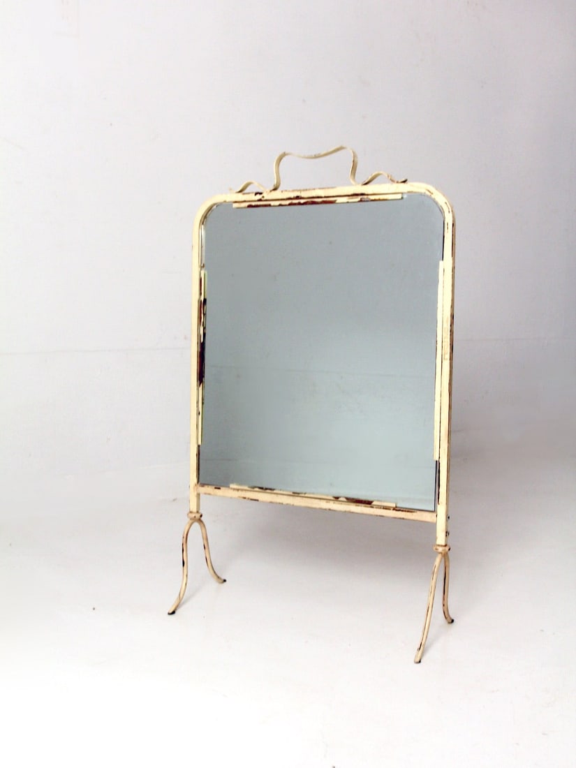 Vintage Art Nouveau Cream Metal Table Mirror 32.25 in: Vintage Art Nouveau Cream Metal Table Mirror 32.25 in This exquisite antique table mirror showcases a cream painted metal frame adorned with intricate Art Nouveau details. Its charming shabby chic app