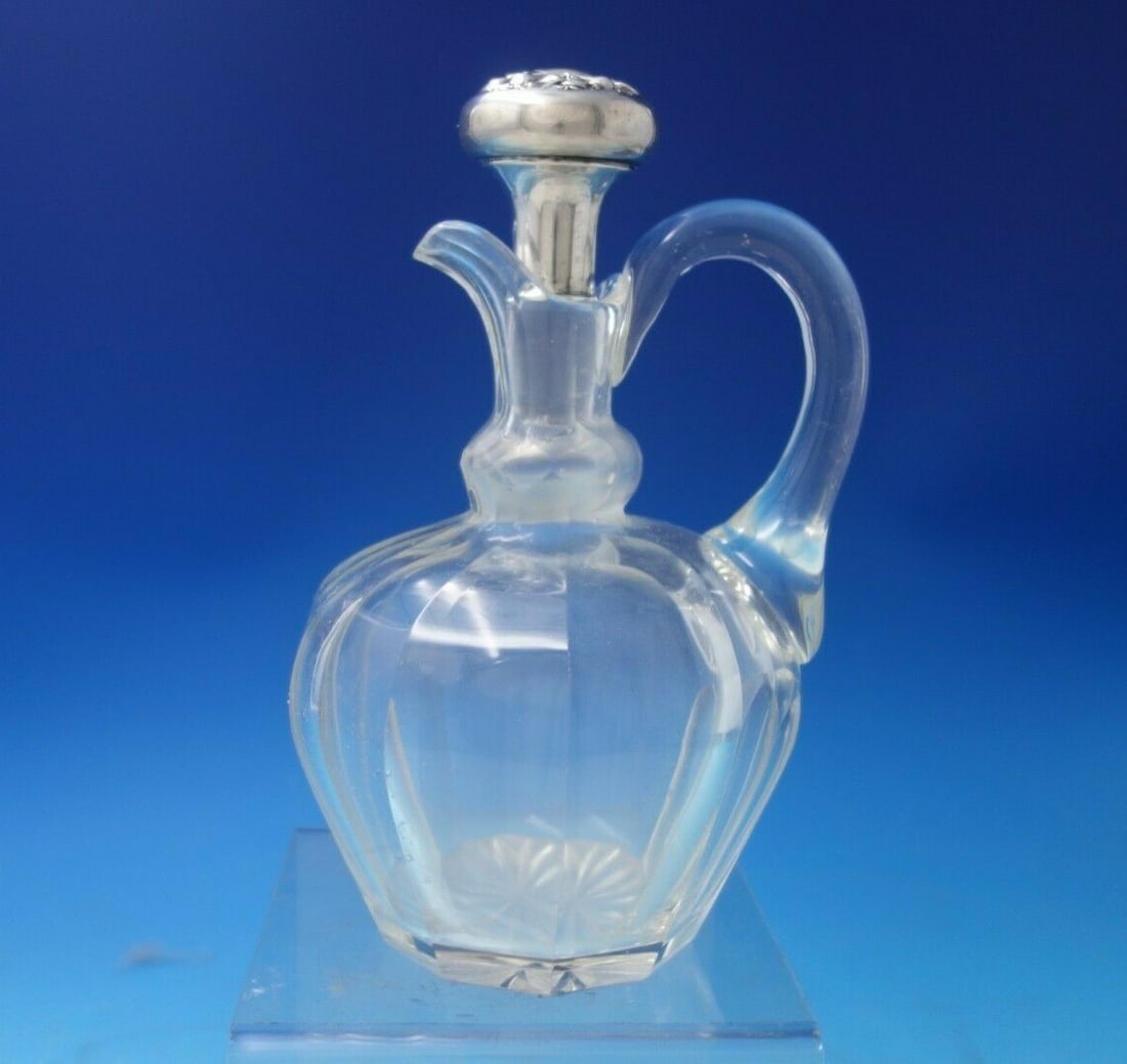Wallace Peony Sterling Silver Cut Crystal Cruet 8.25 inches: Wallace Peony Sterling Silver Cut Crystal Cruet 8.25 inches Discover the elegance of the Peony by Wallace Sterling Silver Cut Crystal Cruet. This exquisite piece features a stunning cut crystal design