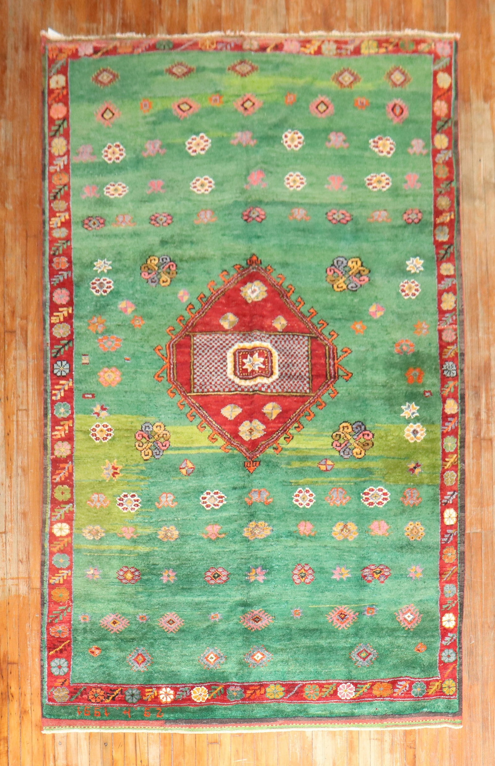 6' 11" x 12' 9" Turkish Konya Tulu rug in green: 6' 11" x 12' 9" Turkish Konya Tulu rug in green Vintage Anatolian Tulu rug from Konya with a grass green field, natural abrash, and full pile construction. Dated 1991 by the weaver, this one-of-a-kind