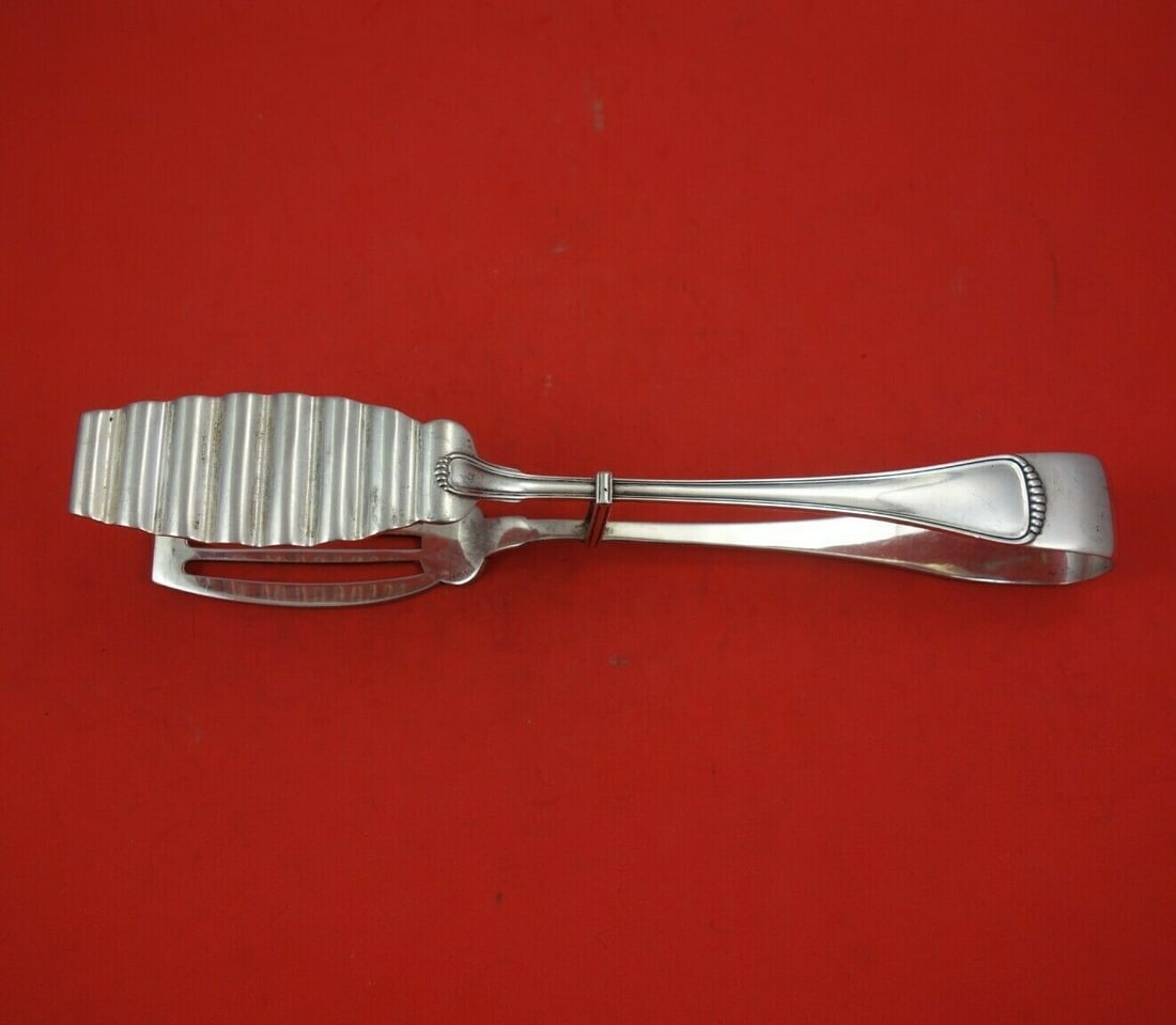 Milano .800 Silver 10 Inch Asparagus Serving Tong with Yoke: Milano .800 Silver 10 Inch Asparagus Serving Tong with Yoke This exquisite asparagus serving tong features a classic Milano pattern, crafted from .800 silver and measuring 10 inches in length. The ton