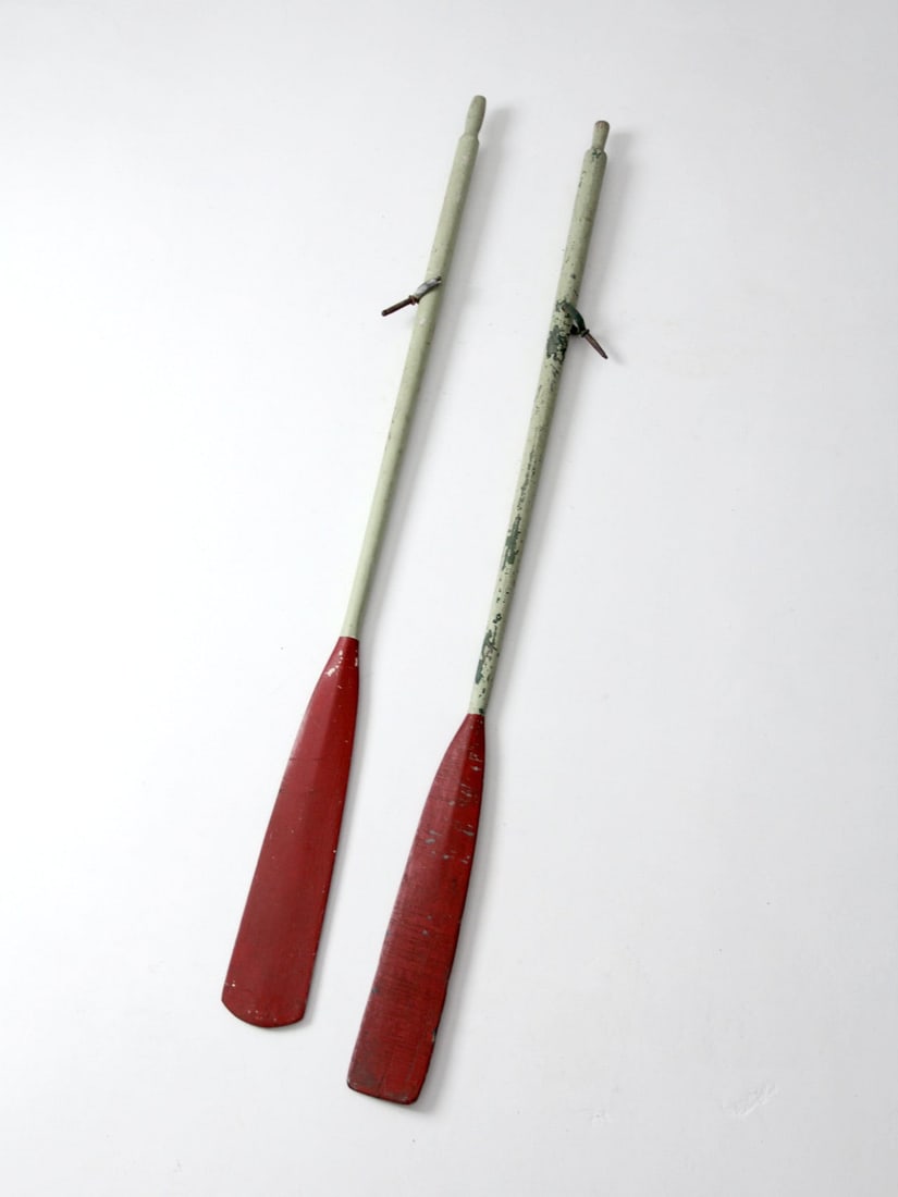 Charming Vintage Hand-Painted Wooden Oars Mismatched Pair: Charming Vintage Hand-Painted Wooden Oars Mismatched Pair Discover a unique pair of vintage wooden oars, each featuring charming hand-painted designs. The oars showcase vibrant red blades paired with 