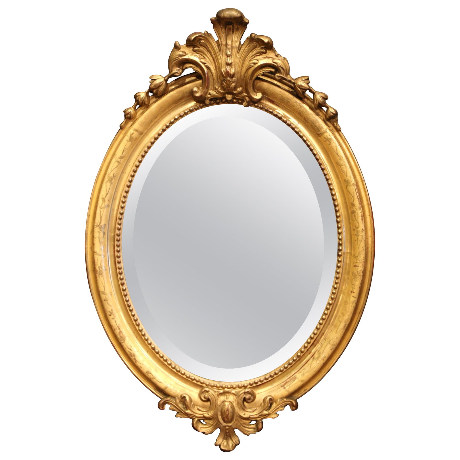 French Louis XV giltwood oval wall mirror with shell cartouche: French Louis XV giltwood oval wall mirror with shell cartouche This late 19th century French Louis XV-style oval mirror showcases exquisite hand-carved giltwood craftsmanship. Made in France circa 187