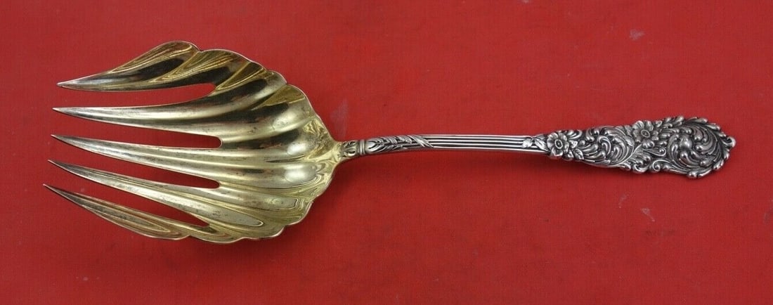 Reed & Barton Trajan Sterling Silver Gold Wash Serving Fork 9 1/8": Reed & Barton Trajan Sterling Silver Gold Wash Serving Fork 9 1/8" This exquisite vegetable serving fork from the Trajan pattern by Reed & Barton is crafted from sterling silver and features a gold wa