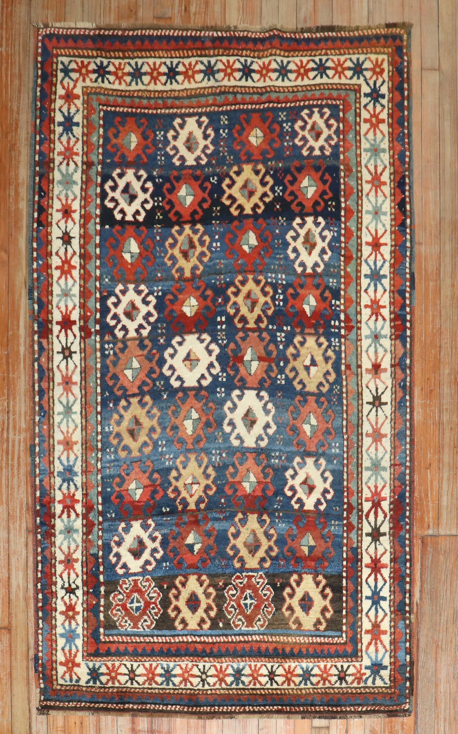 4' 1" x 6' 10" Caucasian Moghan Kazak Accent Rug: 4' 1" x 6' 10" Caucasian Moghan Kazak Accent Rug Late 19th century Moghan Kazak Caucasian rug with a full pile and geometric patterning. This pre-owned accent rug reflects the traditional Kazak style.