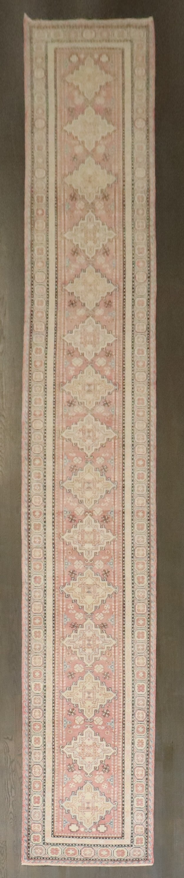 2' 5" x 17' 5" Samarkand runner from East Turkestan: 2' 5" x 17' 5" Samarkand runner from East Turkestan Vintage Samarkand long runner from East Turkestan, dating to the mid-20th century. This long and narrow rug is presented in a soft pink tone and is 