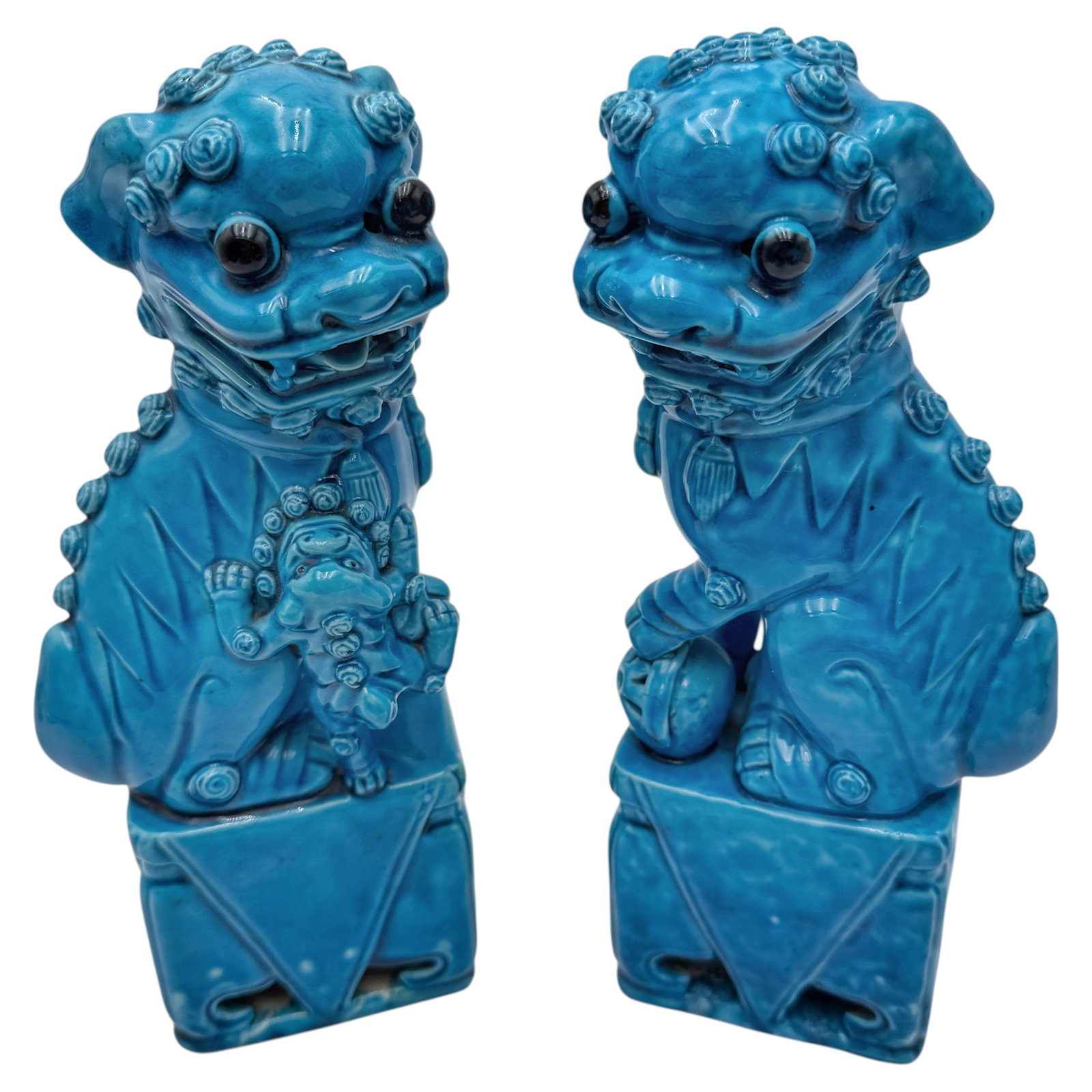 Set of 2 Chinese Export turquoise glazed porcelain guardian lions: Set of 2 Chinese Export turquoise glazed porcelain guardian lions Pair of Chinese guardian lions, also known as Fu Dogs, featuring a vibrant turquoise glazed finish and traditional modeled forms. One 