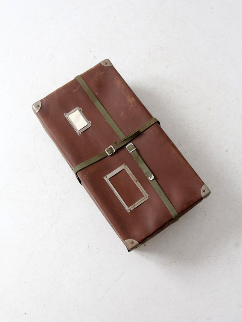 Vintage Brown Fiberboard Mailing Box with Metal Corners: Vintage Brown Fiberboard Mailing Box with Metal Corners This vintage brown vulcanized fiberboard mailing box showcases reinforced metal corners and green canvas straps that buckle securely. With dual 