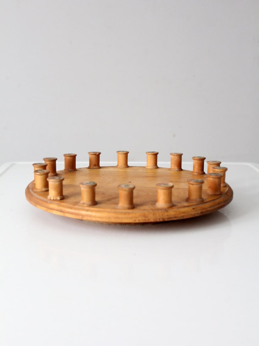 Vintage Folk Art Lazy Susan with Wooden Thread Spools 13 Inch: Vintage Folk Art Lazy Susan with Wooden Thread Spools 13 Inch This vintage lazy Susan showcases a unique artistic flair, featuring a beautifully turned wood tray encircled by a ring of antique wooden 