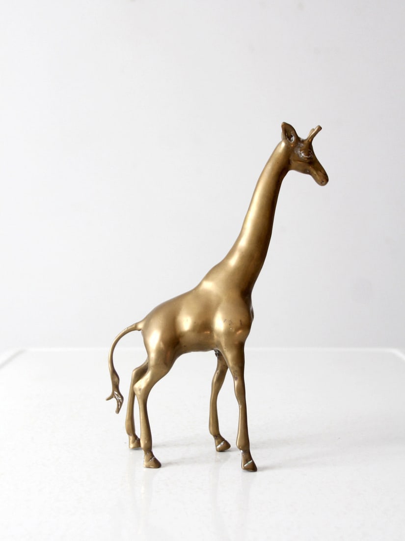 Mid Century Solid Brass Giraffe Figurine 11.5 Inch: Mid Century Solid Brass Giraffe Figurine 11.5 Inch Add a touch of elegance to your decor with this exquisite mid-century brass giraffe figurine. Crafted from solid brass, this piece features sleek det