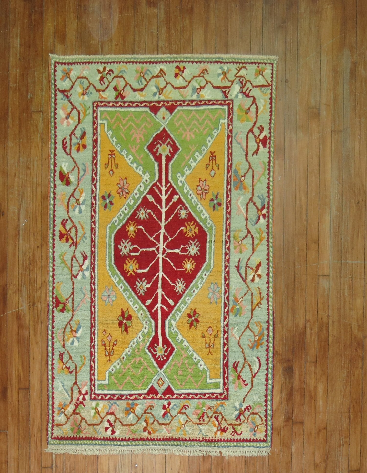 3' 9" x 6' Early 20th Century Turkish Ghiordes Accent Rug: 3' 9" x 6' Early 20th Century Turkish Ghiordes Accent Rug Early 20th century Turkish Ghiordes accent rug with bright colors and a central geometric design framed by floral and vine motifs. This pre-ow