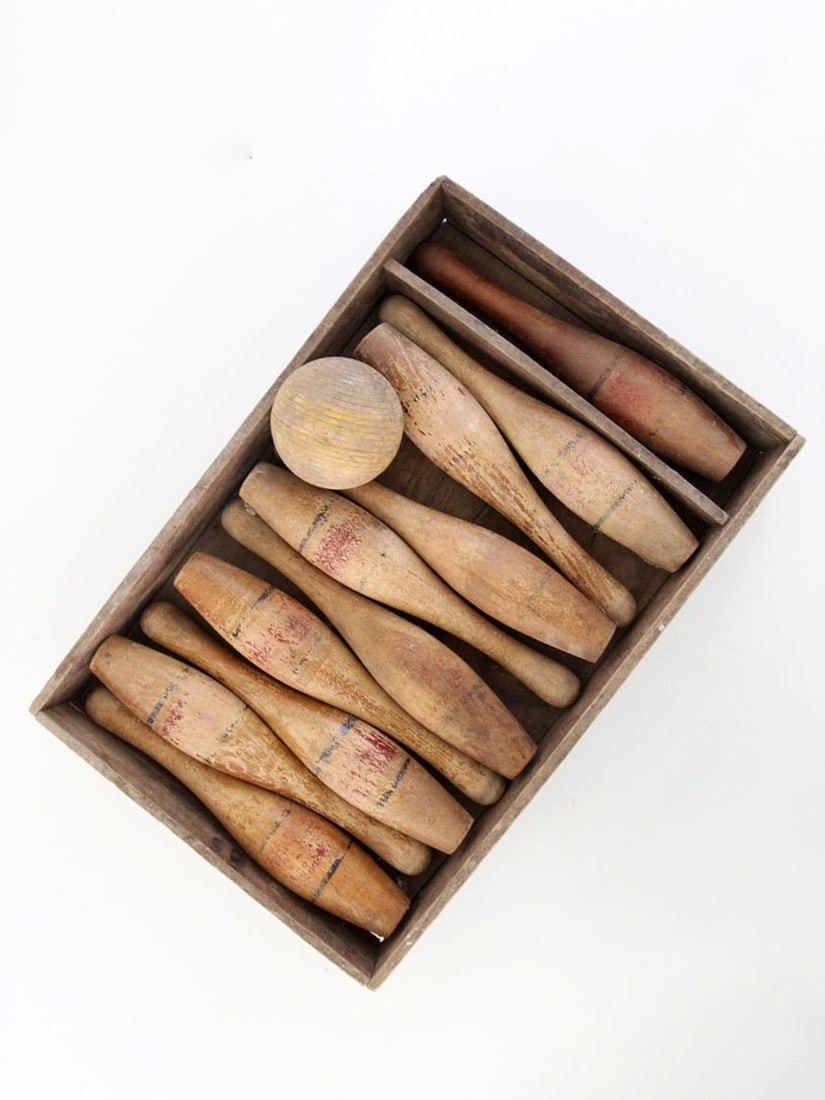 Early 20th Century Wooden Bowling Set With Pins Ball And Storage Box: Early 20th Century Wooden Bowling Set With Pins Ball And Storage Box This early 20th century wooden bowling pins set features a group of turned pins with softened painted banding and a solid wood ball