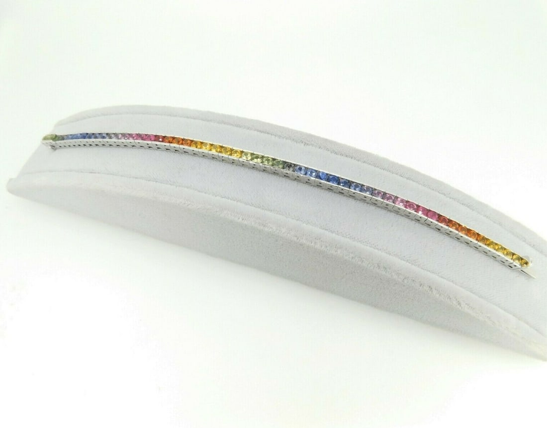 14k White Gold Rainbow Sapphire Tennis Bracelet 8.70 Carats: 14k White Gold Rainbow Sapphire Tennis Bracelet 8.70 Carats This 14k white gold tennis bracelet features 8.70 carats of genuine, natural, diamond-cut round sapphires. The sapphires display a vibrant d