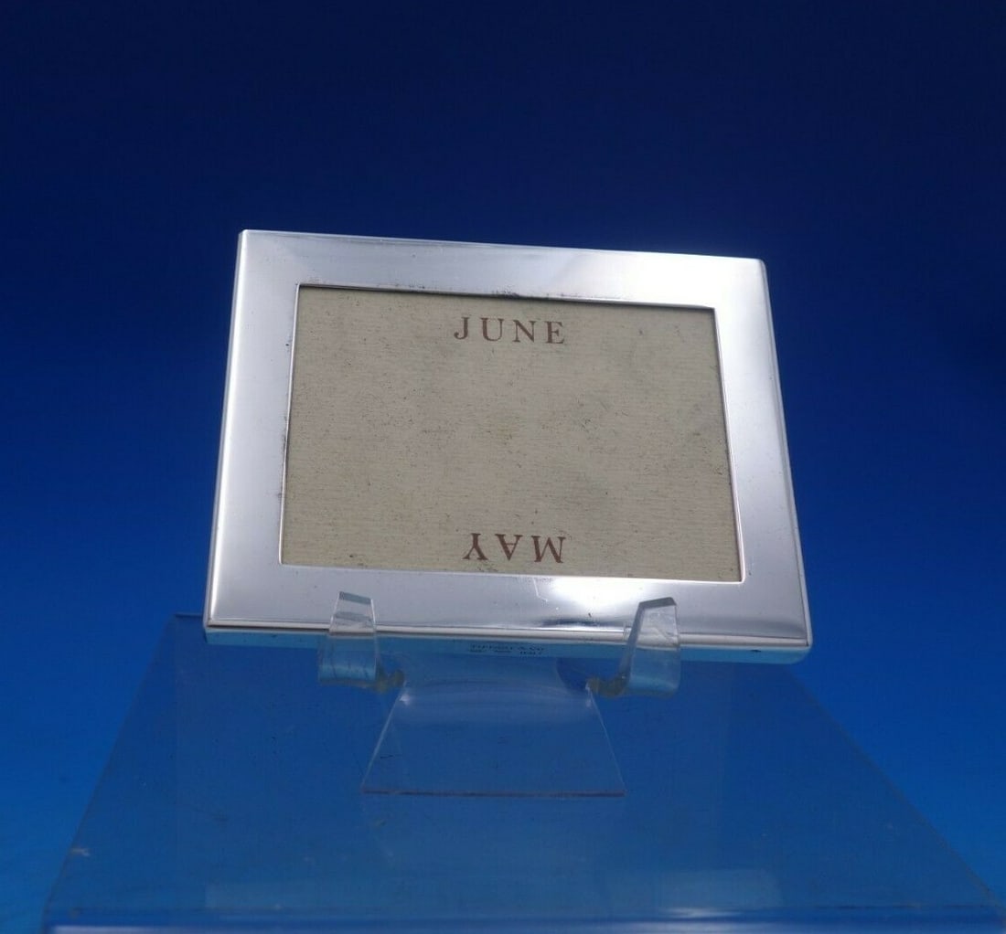 Tiffany Co Sterling Silver Desk Calendar Frame Made in Italy 3 3/4" x 2 7/8": Tiffany Co Sterling Silver Desk Calendar Frame Made in Italy 3 3/4" x 2 7/8" Tiffany & Co. Italian sterling silver desk calendar frame, made in Italy. This horizontal frame measures 3 3/4" x 2 7/8" an