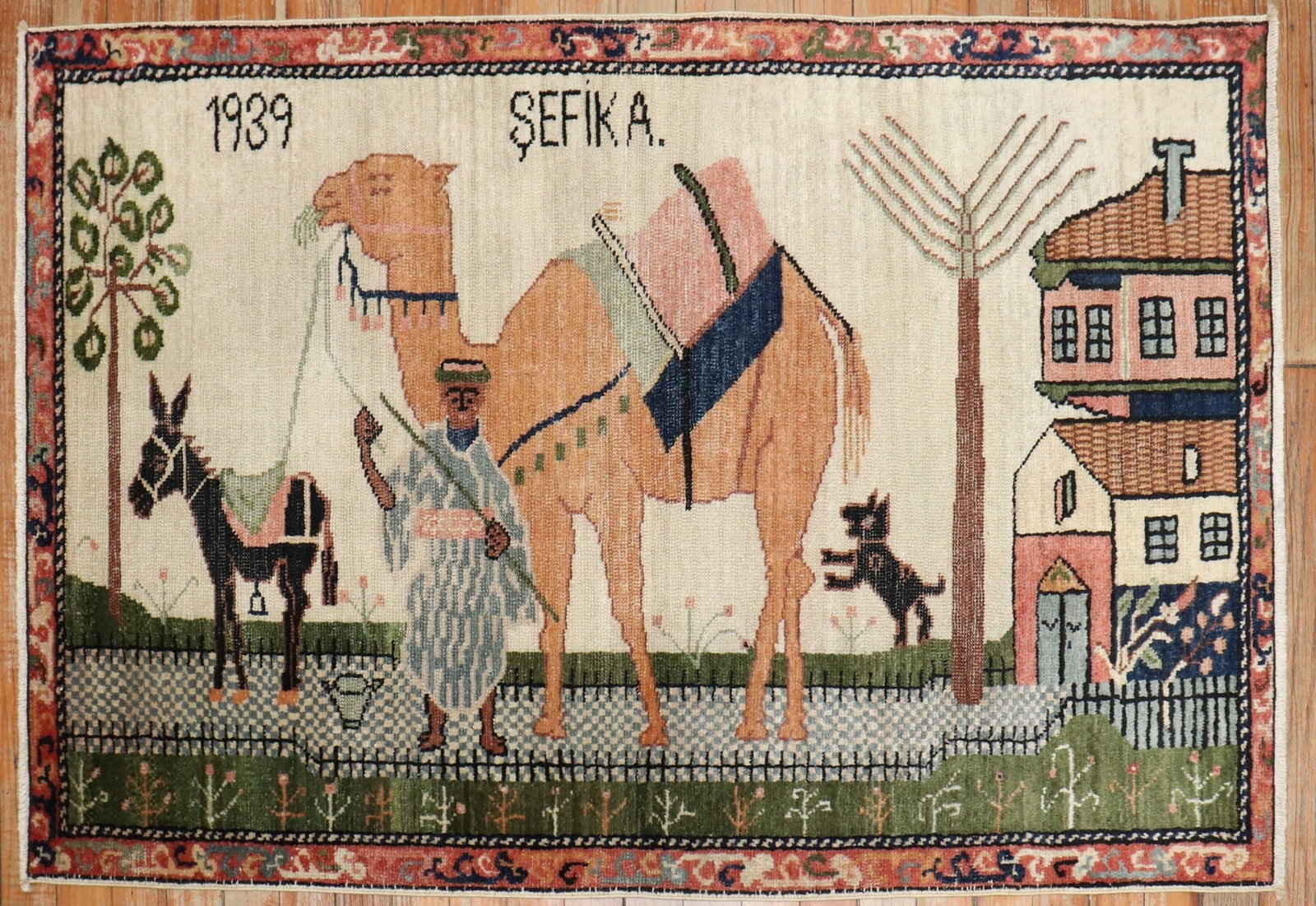 2' 8" x 4' 2" Turkish Anatolian pictorial rug dated 1939: 2' 8" x 4' 2" Turkish Anatolian pictorial rug dated 1939 Vintage Turkish Anatolian pictorial rug dated 1939. This small pre-owned rug features a figural scene with a camel, a person, and a donkey in a