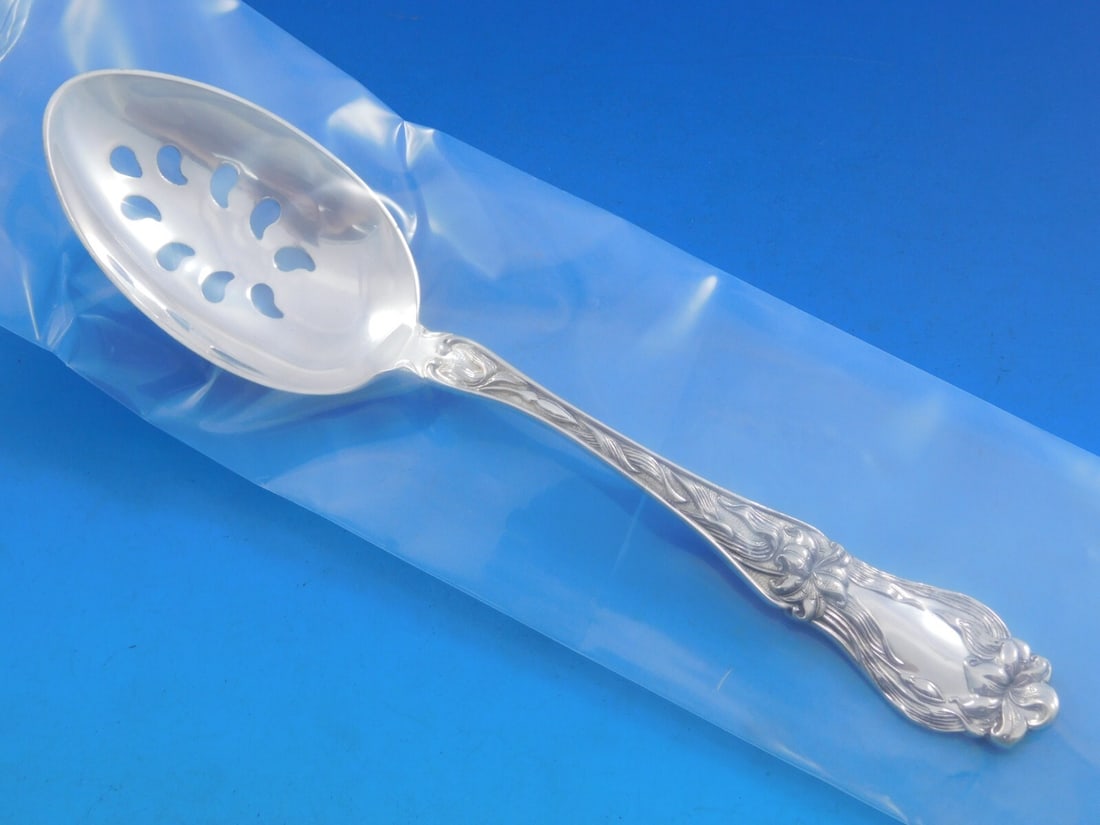 Frank Whiting Lily Sterling Silver 9-Hole Slotted Serving Spoon 8 1/8": Frank Whiting Lily Sterling Silver 9-Hole Slotted Serving Spoon 8 1/8" Elevate your dining experience with this exquisite serving spoon from the renowned Frank M. Whiting, featuring the elegant Lily p