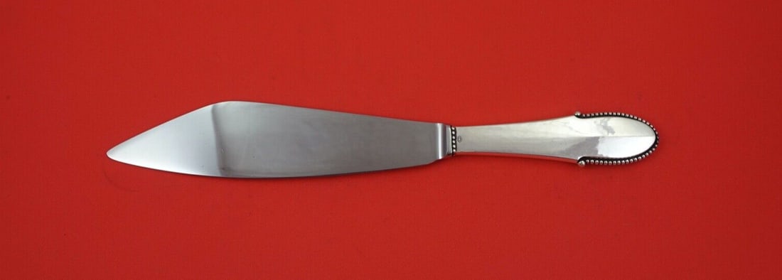 Georg Jensen Beaded Sterling Silver Cake Knife 10 3/8 Inch Wide No Notch: Georg Jensen Beaded Sterling Silver Cake Knife 10 3/8 Inch Wide No Notch This exquisite cake knife features the elegant Beaded pattern by Georg Jensen, crafted from high-quality sterling silver. The k