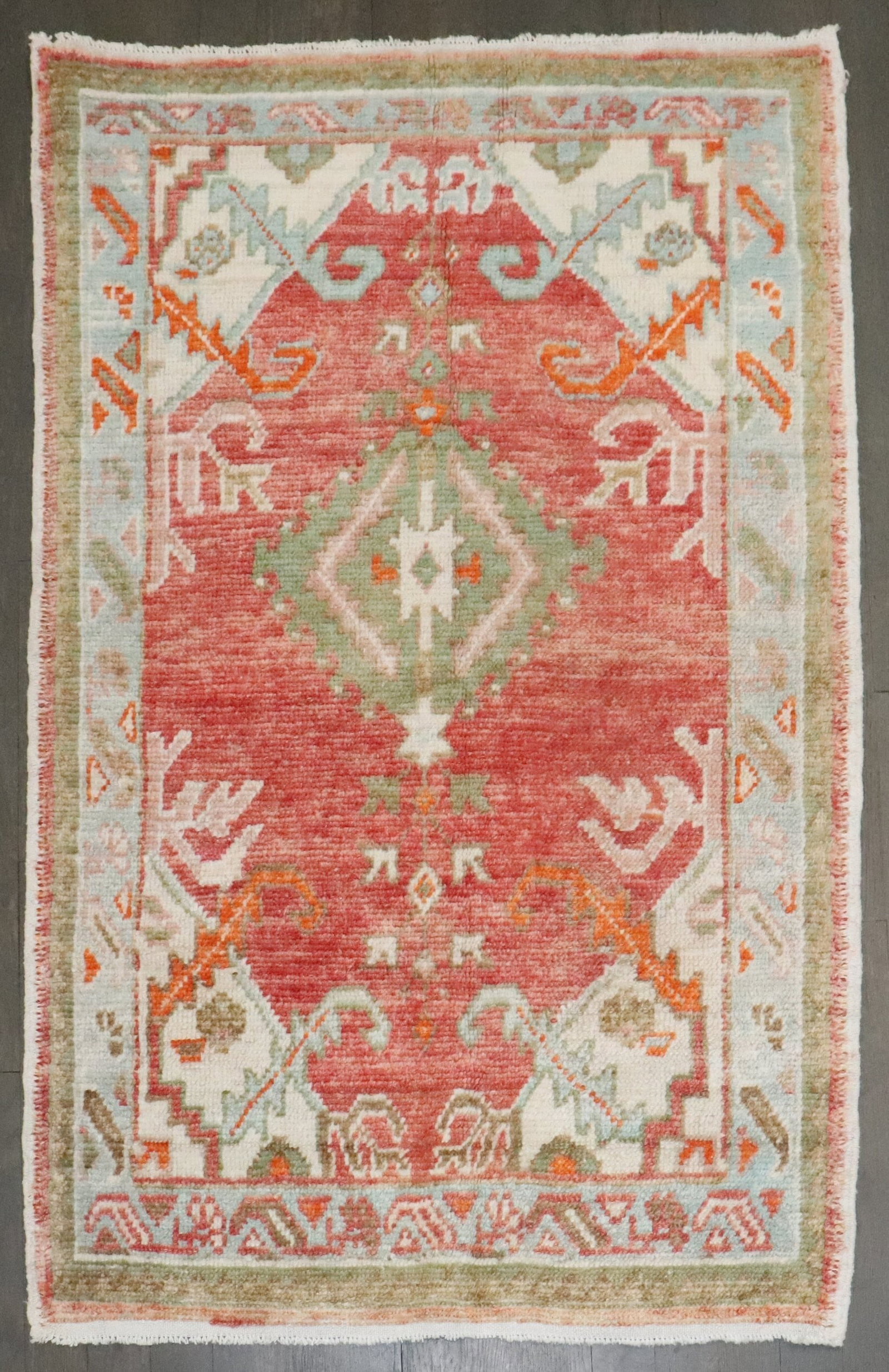 2' 7" x 3' 11" Vintage Turkish Anatolian Oushak Rug: 2' 7" x 3' 11" Vintage Turkish Anatolian Oushak Rug Vintage Turkish Anatolian Oushak rug featuring an off-center medallion on a red field. A distinctive small-format piece with pre-owned condition. Sp