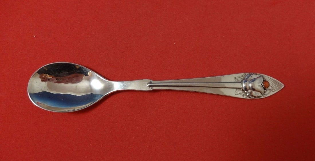 Georg Jensen Ornamental #5 Sterling Silver Sugar Spoon with Coral Cabochon: Georg Jensen Ornamental #5 Sterling Silver Sugar Spoon with Coral Cabochon Add a touch of elegance to your table setting with this Ornamental #5 Sugar Spoon by Georg Jensen. Crafted from high-quality 