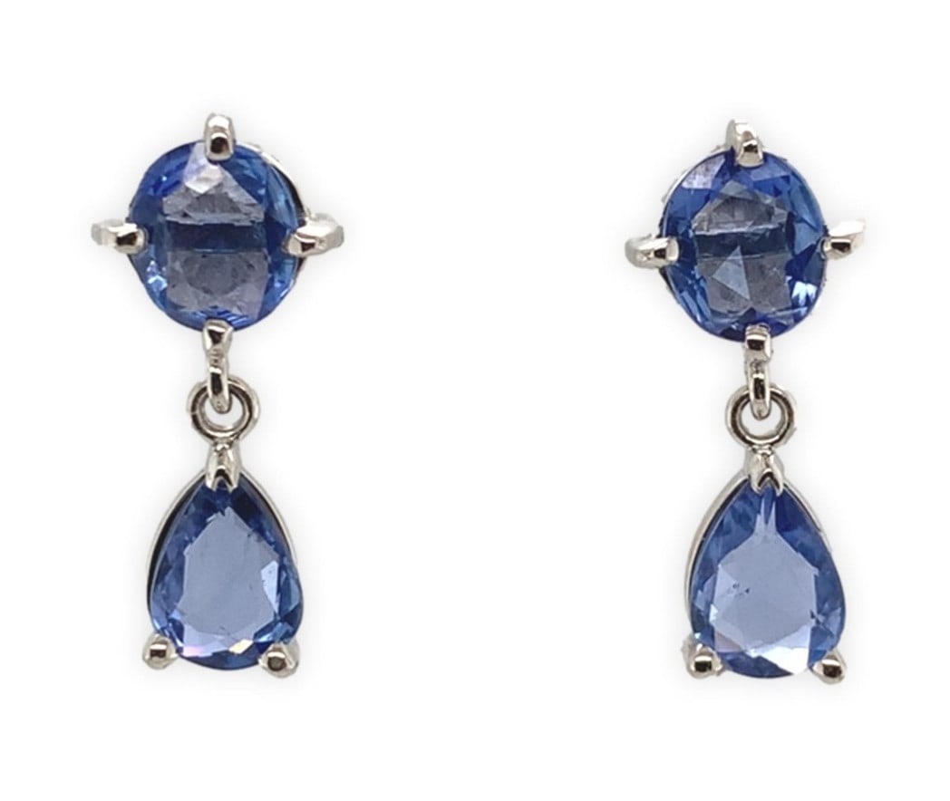 Platinum Drop Earrings with 2.41 ct Blue Sapphire Pair: Platinum Drop Earrings with 2.41 ct Blue Sapphire Pair Platinum dangle/drop earrings featuring genuine blue sapphires with a total carat weight of 2.41 ct. The design includes round and pear-shaped ro