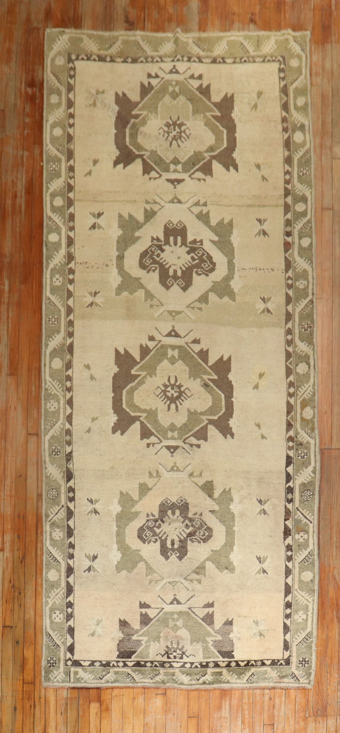 4' 10" x 12' 9" Turkish Oushak Anatolian Gallery Rug: 4' 10" x 12' 9" Turkish Oushak Anatolian Gallery Rug Vintage Turkish Oushak Anatolian gallery rug from the mid 20th century. This pre-owned rectangular rug features a geometric pattern with floral mot