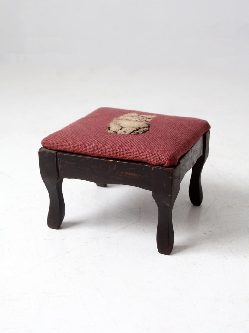 Midcentury Footstool with Rose Red Needlepoint Cat Motif and Curved Wood Base: Midcentury Footstool with Rose Red Needlepoint Cat Motif and Curved Wood Base This vintage footstool showcases a needlepoint cat motif on a rose-red upholstered top, supported by a dark wood base with