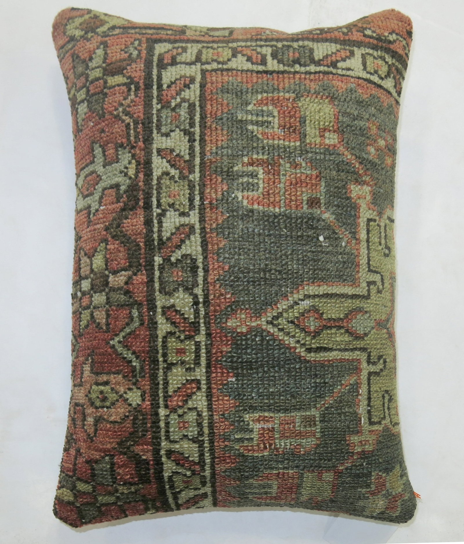 1920s Persian Heriz Rug Pillow 1' 1" x 1' 6": 1920s Persian Heriz Rug Pillow 1' 1" x 1' 6" Decorative pillow made from a 1920s Persian Heriz rug in an earth-toned design. This pre-owned pillow is categorized as a Serapi/Heriz type. Specifications