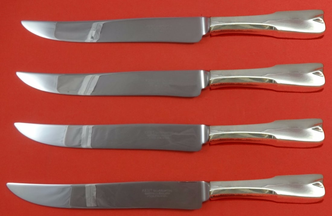 Lunt Colonial Theme Sterling Silver Steak Knife Set 4pc Texas Sized: Lunt Colonial Theme Sterling Silver Steak Knife Set 4pc Texas Sized Enhance your dining experience with this impressive 4-piece steak knife set from Lunt, featuring the elegant Colonial Theme pattern.