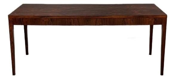Mid-Century Riis Antonsen Danish Rosewood Desk with 3 Drawers: Mid-Century Riis Antonsen Danish Rosewood Desk with 3 Drawers This exquisite mid-century modern desk, designed by Riis Antonsen, showcases the elegant beauty of rosewood with its sleek lines and finis